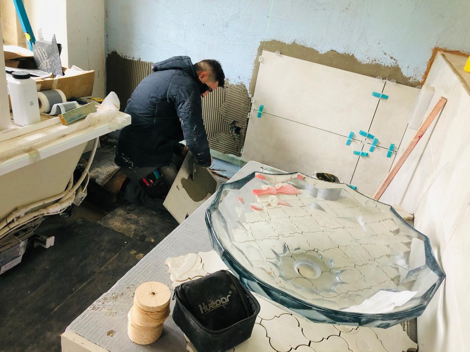 Builder fitting the shower screen and tray